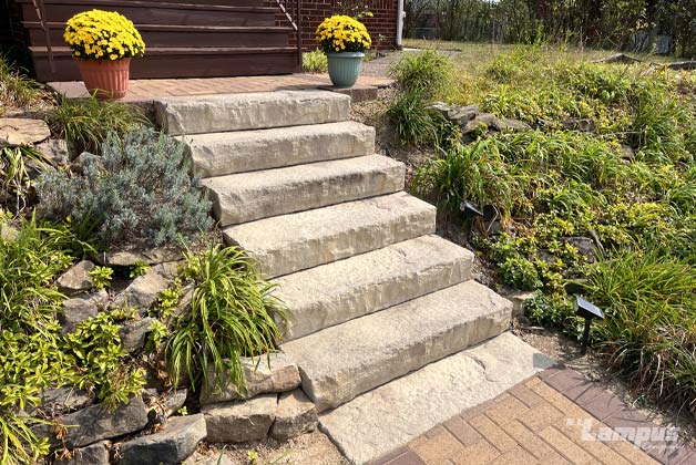 Natural stone staircase with landscape integration and boulder accents