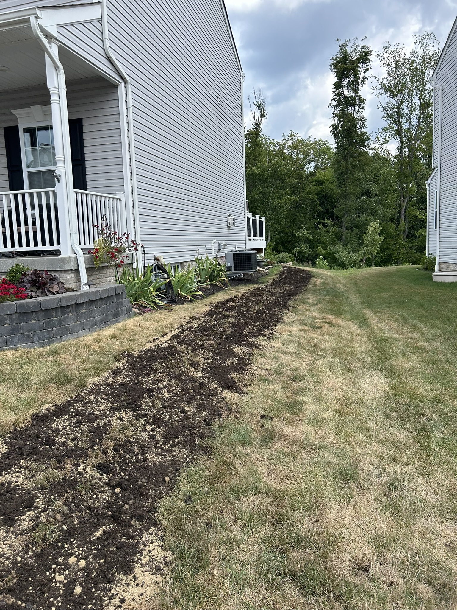 Side yard landscape prep with new soil installation and bed expansion